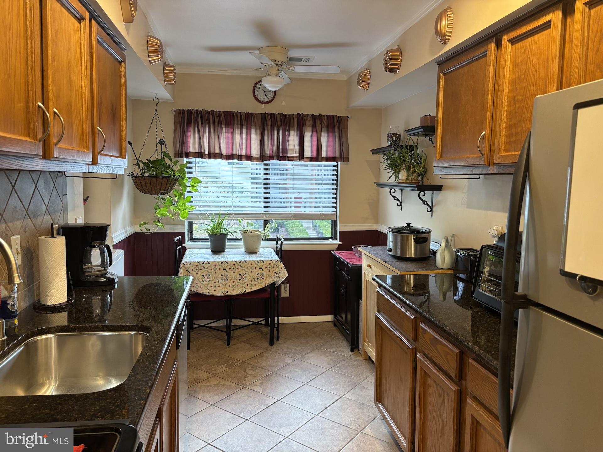 4220 Crystal Court, Unit 3D Hampstead, MD 21074 - Photo 8 of 16 a kitchen with granite countertop a sink stainless steel appliances and cabinets