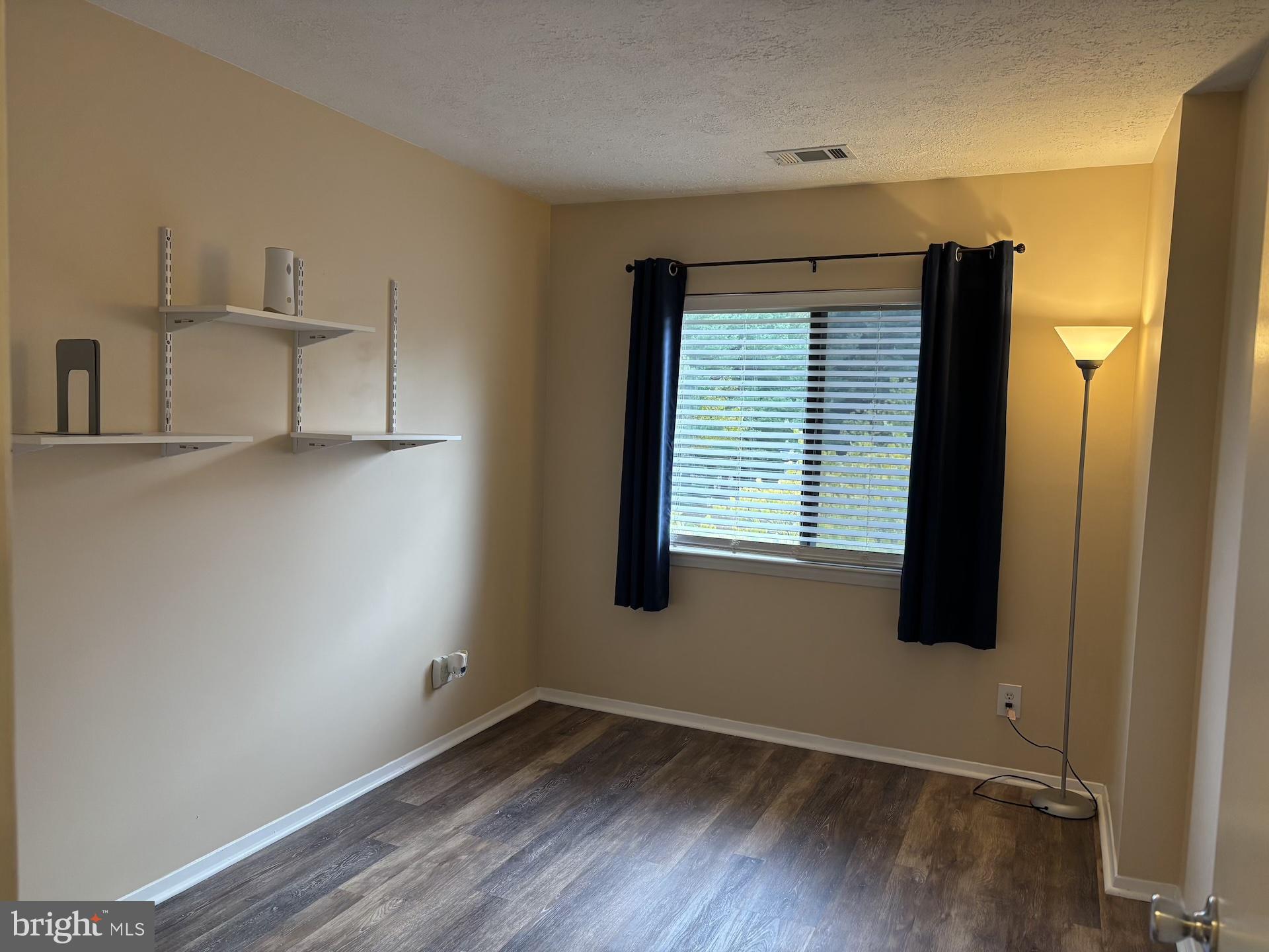 4220 Crystal Court, Unit 3D Hampstead, MD 21074 - Photo 9 of 16 a view of an empty room with wooden floor and a window