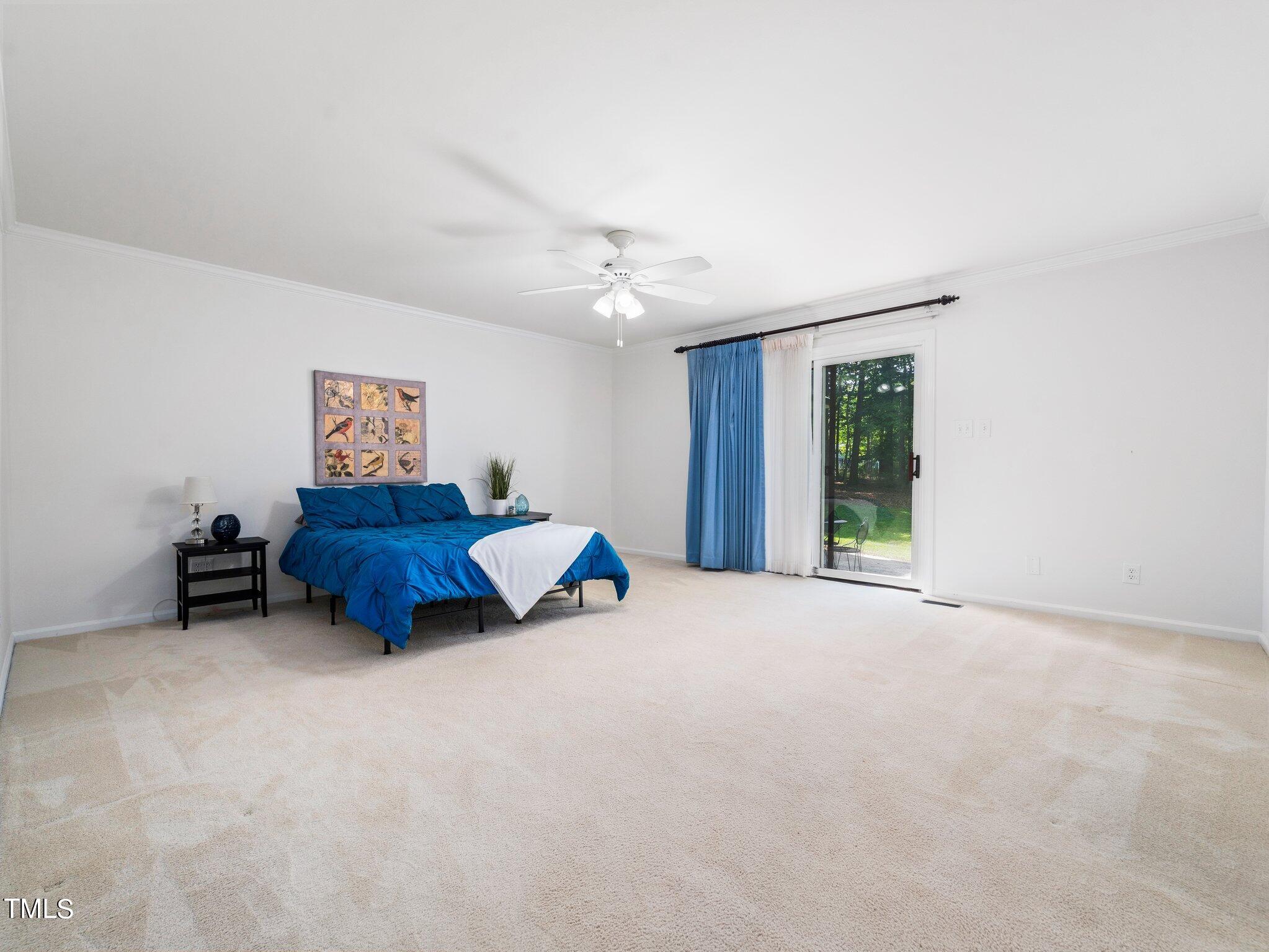 512 Brittany Bay West Raleigh, NC 27614 - Photo 12 of 27 a spacious bedroom with a bed and a window