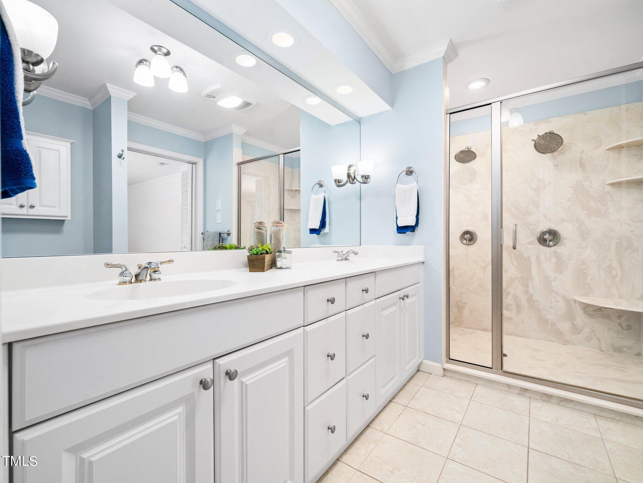 512 Brittany Bay West Raleigh, NC 27614 - Photo 14 of 27 a bathroom with a shower sink and mirror