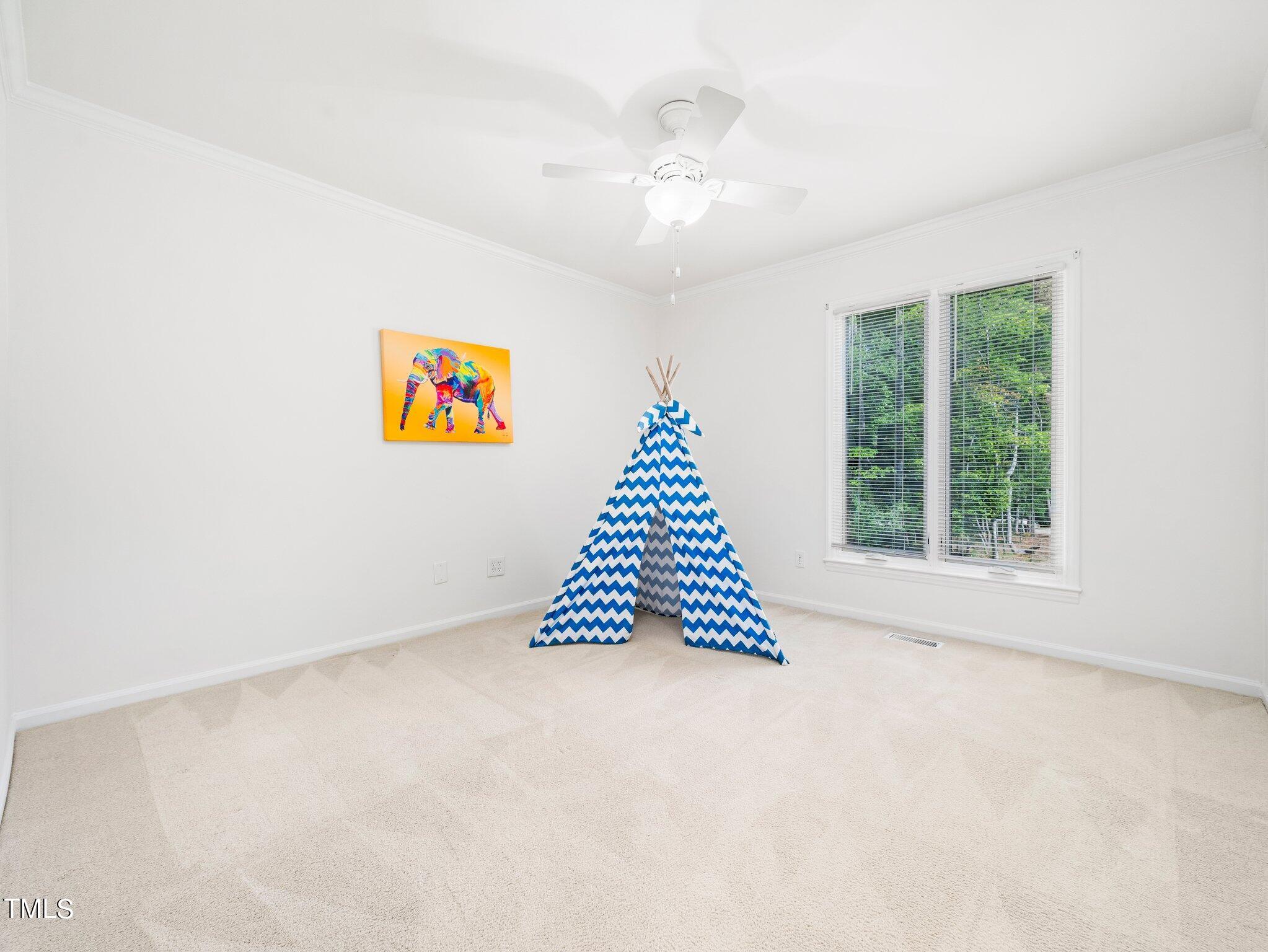 512 Brittany Bay West Raleigh, NC 27614 - Photo 16 of 27 an empty room with windows and chandelier