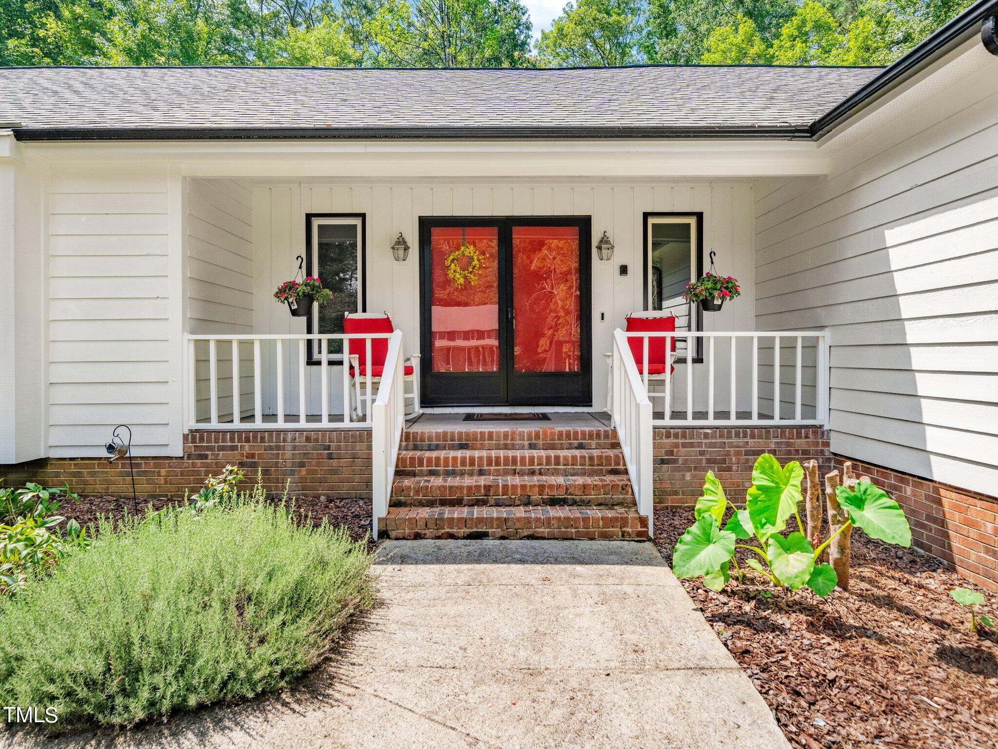 512 Brittany Bay West Raleigh, NC 27614 - Photo 2 of 27 a front view of a house with a garden