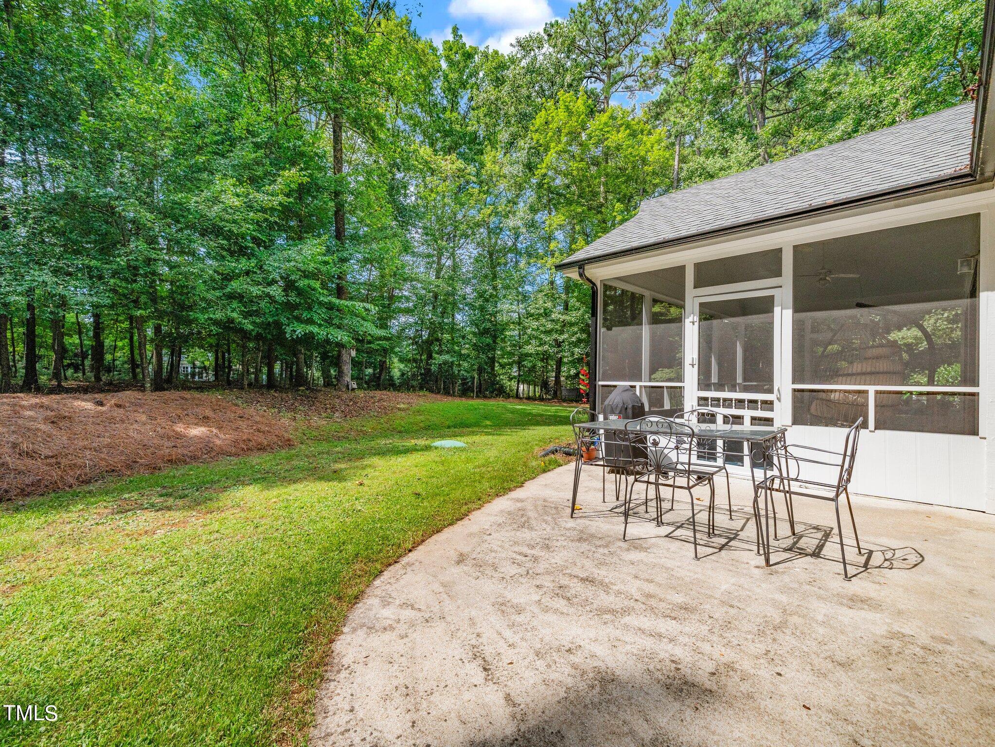 512 Brittany Bay West Raleigh, NC 27614 - Photo 23 of 27 a view of a house with backyard and a sitting area