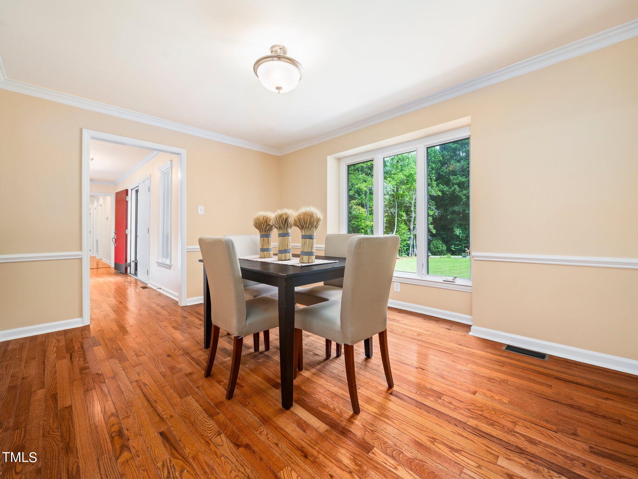 512 Brittany Bay West Raleigh, NC 27614 - Photo 10 of 27 a view of a dining room with furniture and wooden floor