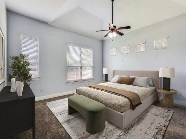 a bedroom with a large bed and a window