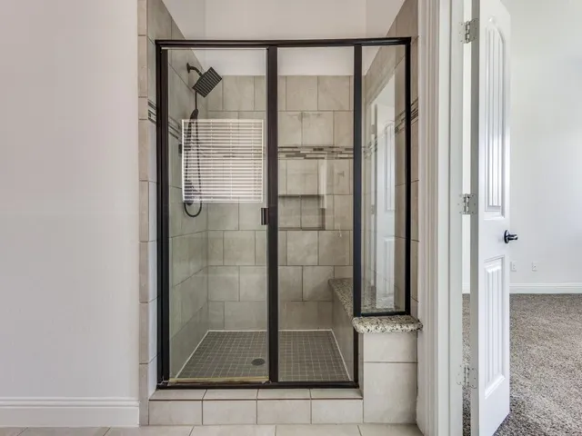 a bathroom with a glass shower door