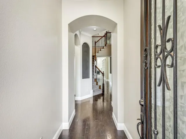 a view of hallway with wooden floor