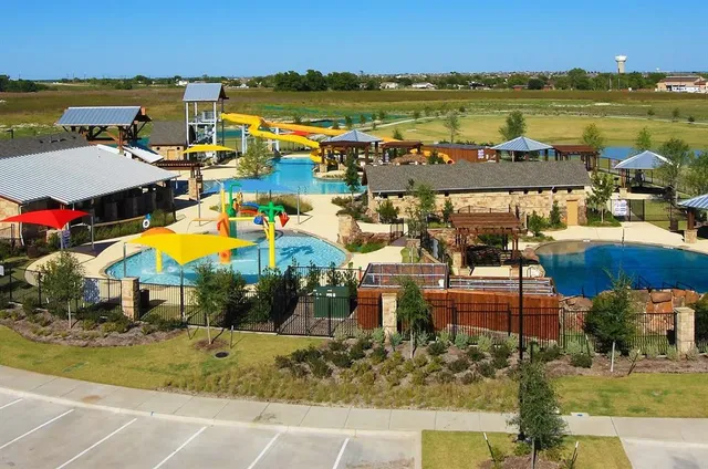 a street sign on a sidewalk next to a road
