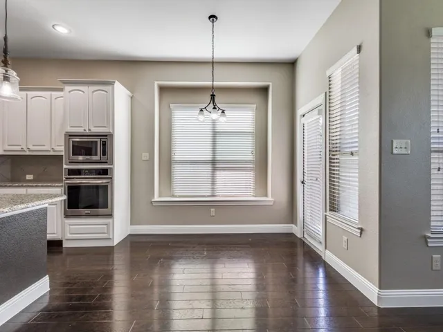 a view of a kitchen with a sink and dishwasher wooden floor