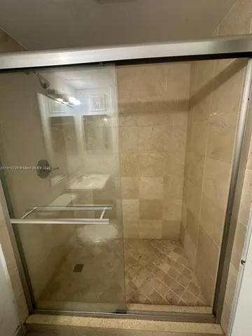 a view of a bathroom with a sink and mirror