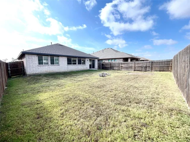 a view of a house with a iron fence