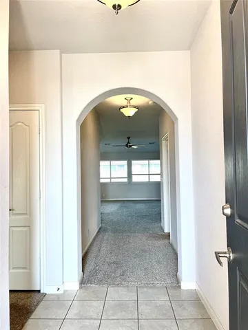 a view of a kitchen with a sink and dishwasher a refrigerator with white cabinets