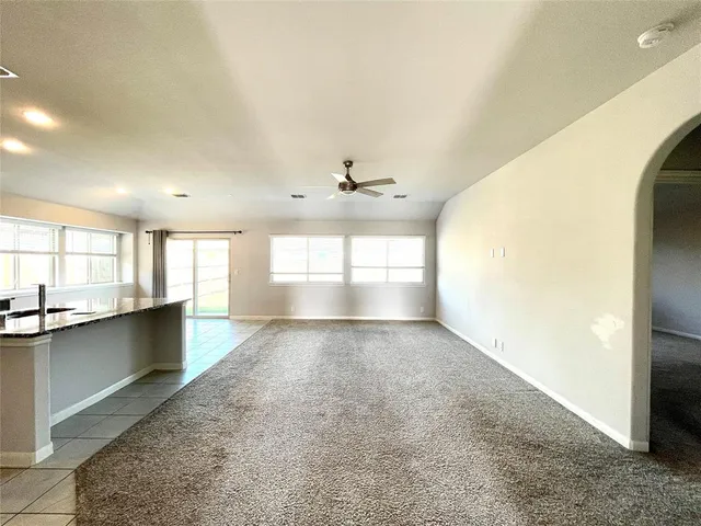 a view of a kitchen with a sink and a window