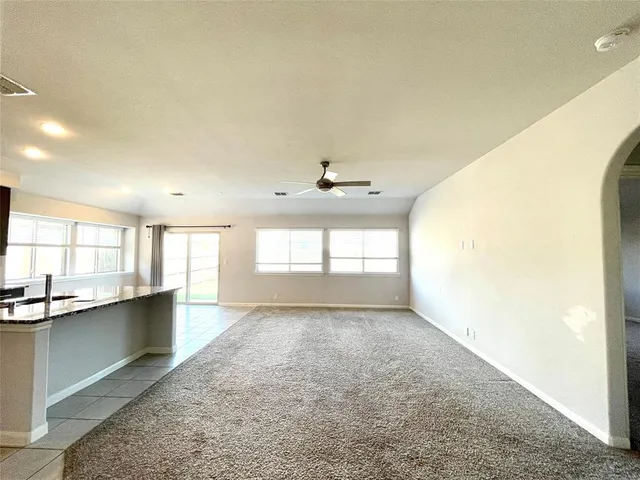 a kitchen with kitchen island granite countertop a sink cabinets and window