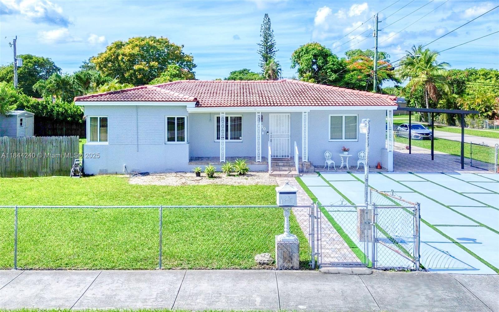 6290 Southwest 37th Street Miami, FL 33155 - Photo 1 of 34 a front view of house with yard and green space