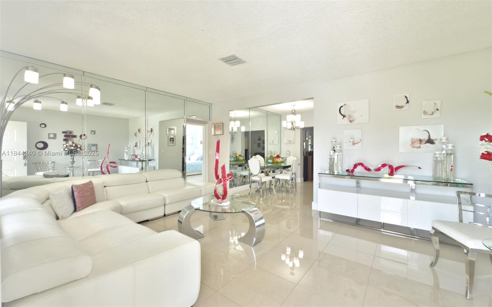6290 Southwest 37th Street Miami, FL 33155 - Photo 13 of 34 a living room with furniture and a large mirror