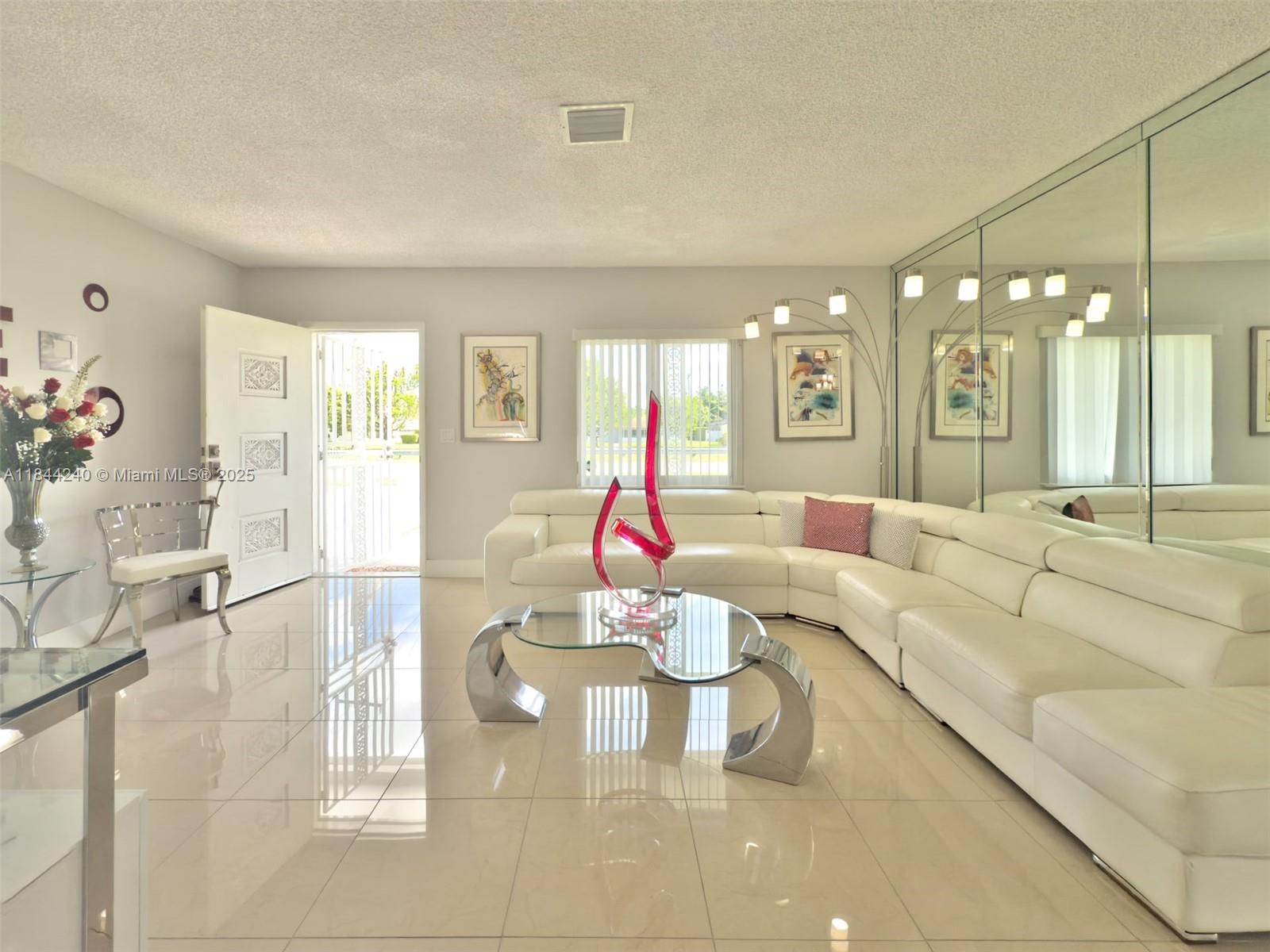 6290 Southwest 37th Street Miami, FL 33155 - Photo 14 of 34 a living room with furniture and a chandelier