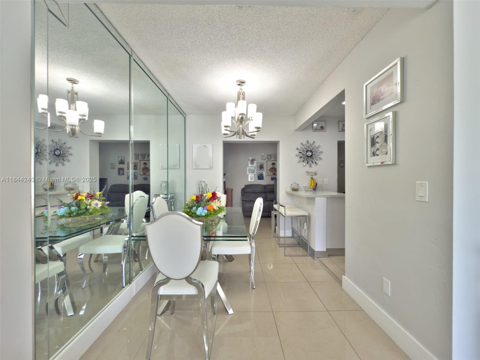 6290 Southwest 37th Street Miami, FL 33155 - Photo 16 of 34 a dining room with furniture and a chandelier