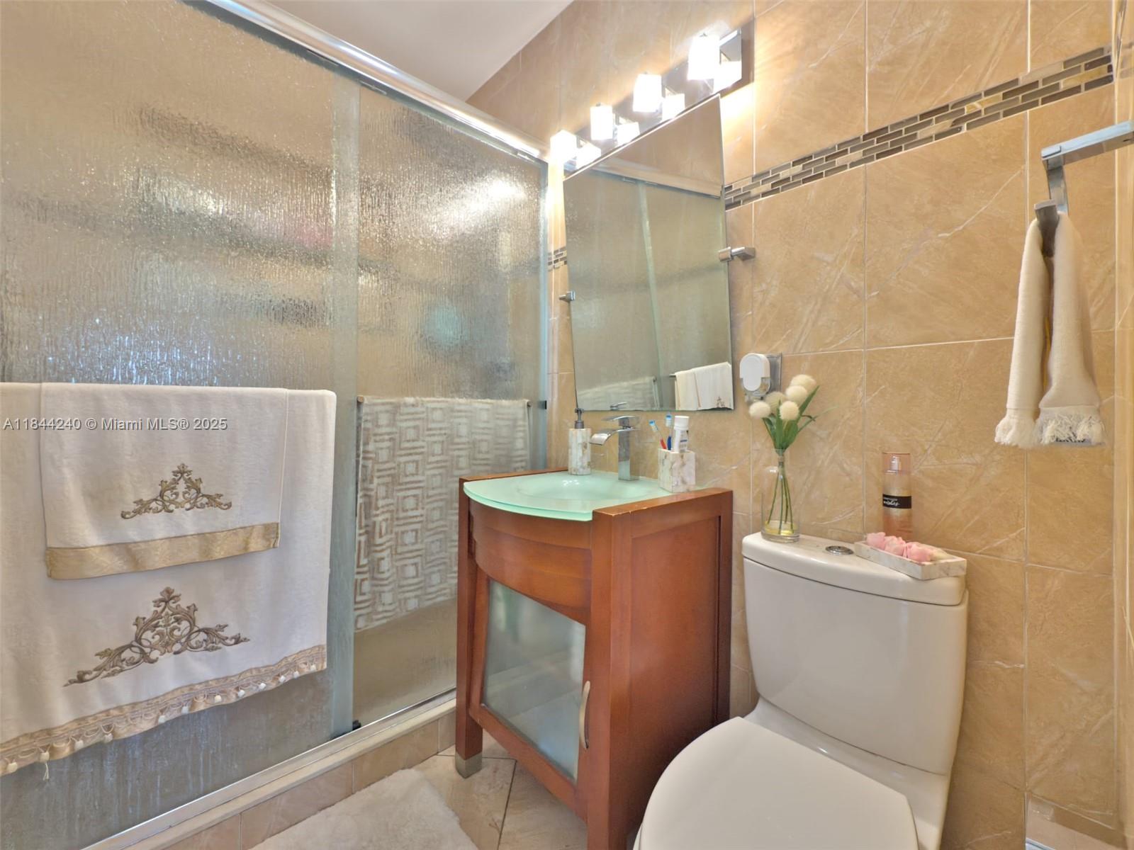 6290 Southwest 37th Street Miami, FL 33155 - Photo 20 of 34 a bathroom with a sink toilet and shower