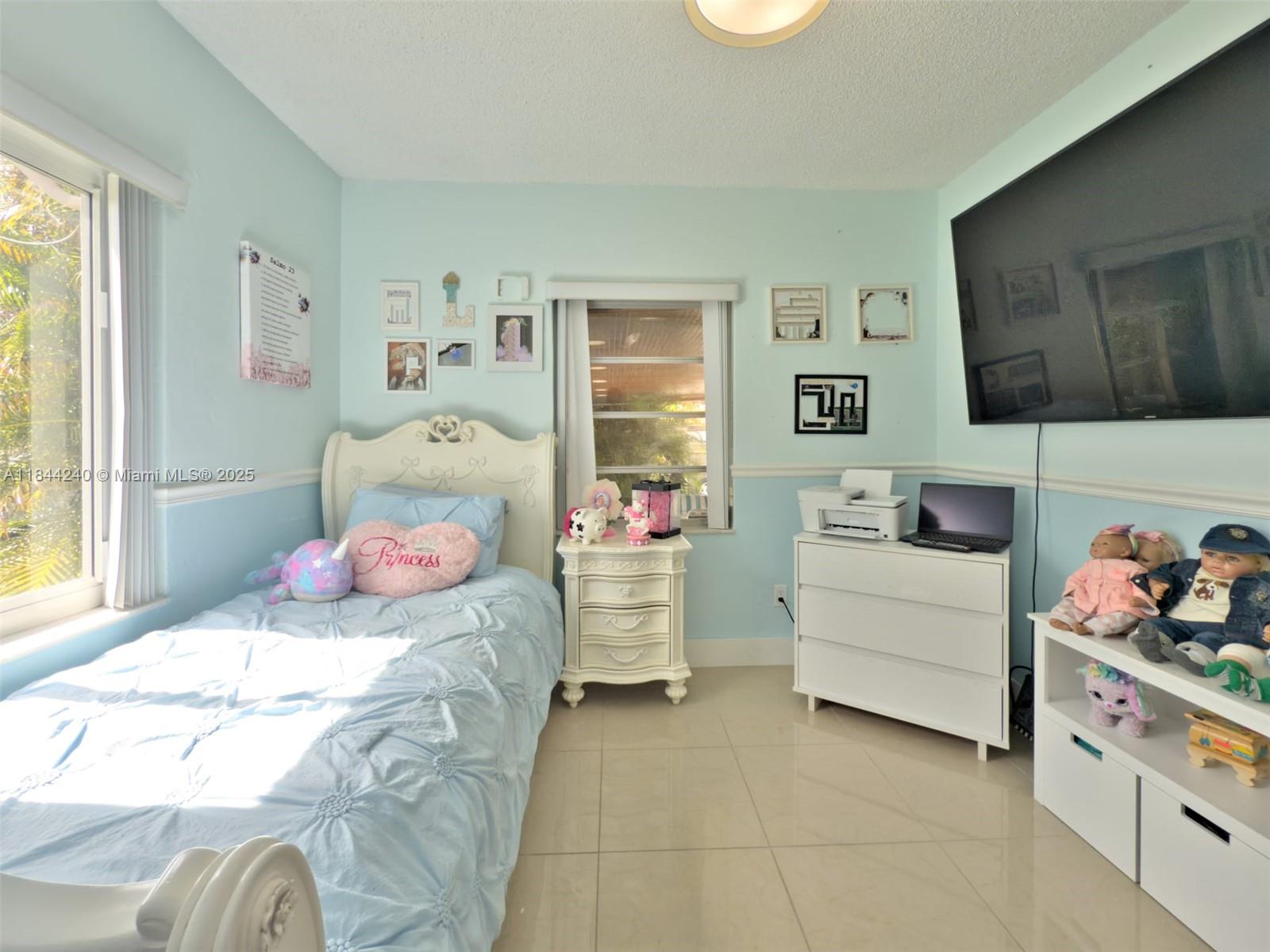 6290 Southwest 37th Street Miami, FL 33155 - Photo 22 of 34 a bedroom with a bed and a window