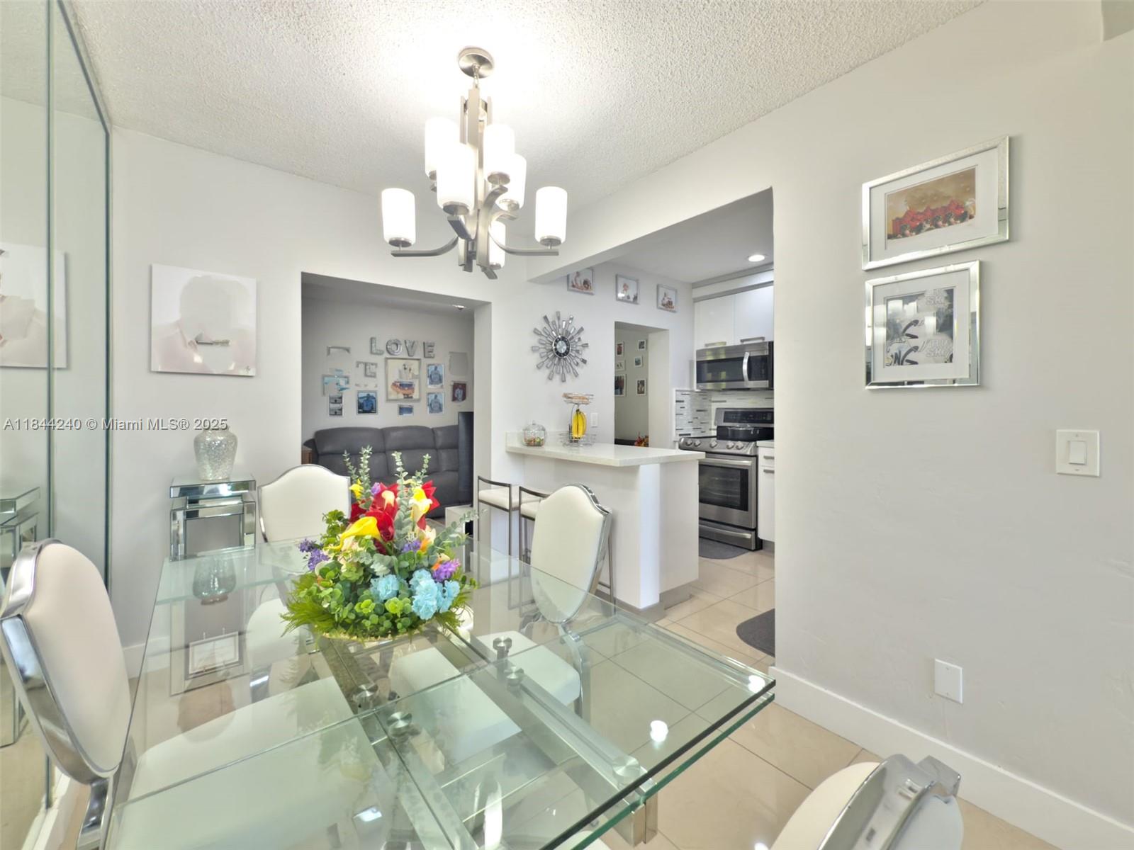 6290 Southwest 37th Street Miami, FL 33155 - Photo 23 of 34 a living room with furniture and a chandelier