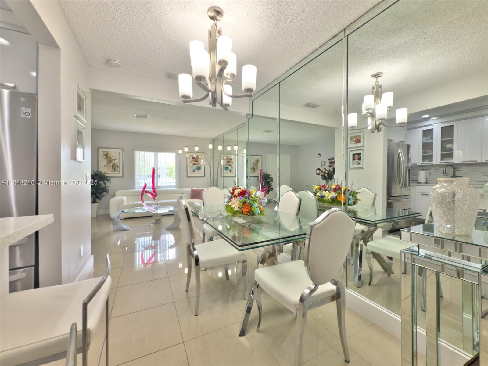 6290 Southwest 37th Street Miami, FL 33155 - Photo 25 of 34 a view of a dining room with furniture and chandelier