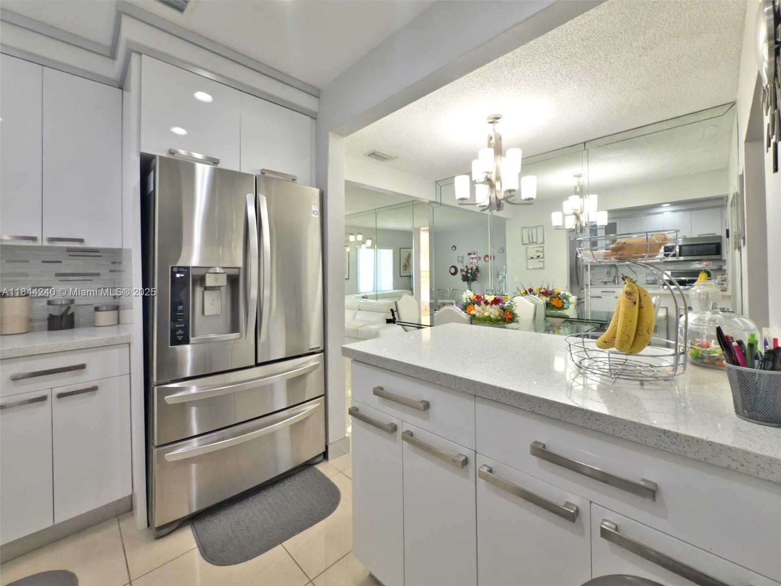 6290 Southwest 37th Street Miami, FL 33155 - Photo 28 of 34 a kitchen with a refrigerator sink and cabinets