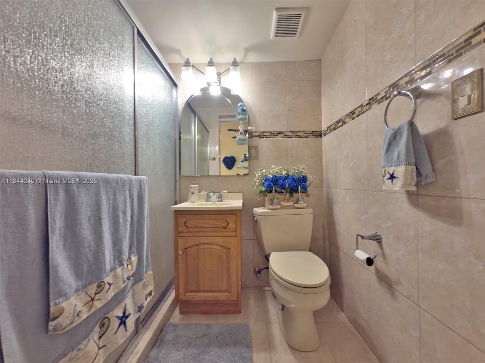 6290 Southwest 37th Street Miami, FL 33155 - Photo 34 of 34 a bathroom with a toilet a sink and a mirror