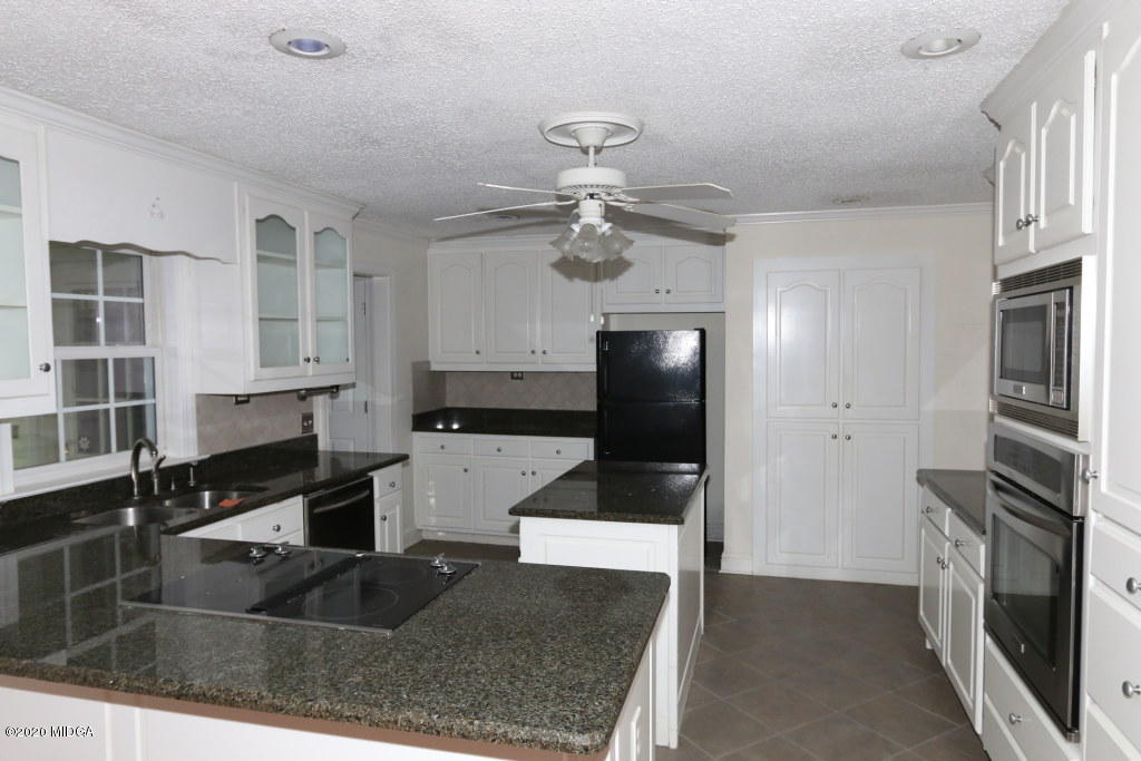 5981 Huddersfield Road Macon, GA 31210 - Photo 8 of 17 a kitchen with stainless steel appliances granite countertop a refrigerator a stove and a sink