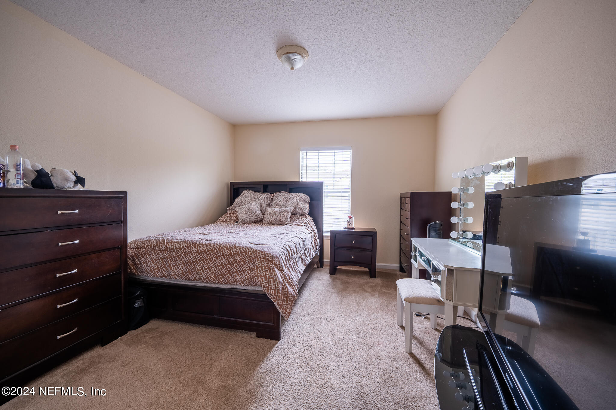 6700 Bowden Road, Unit 2003 Jacksonville, FL 32216 - Photo 23 of 30 a bedroom with a bed and a flat screen tv