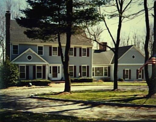 17 Collinswood Road Wilton, CT 06897 - Photo 1 of 1 a front view of a house with a yard table and chairs