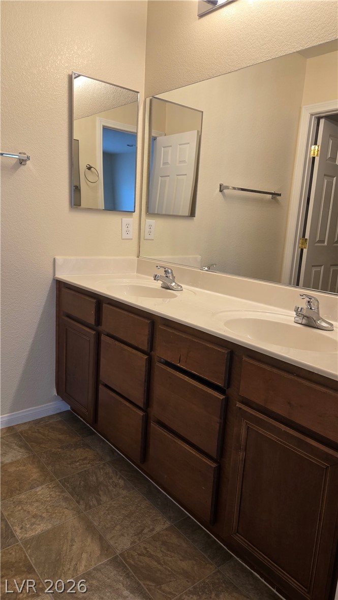 9031 Spring Star Court Las Vegas, NV 89148 - Photo 15 of 17 Double vanity offers ample space, complementing the clean lines of the full-width mirror.