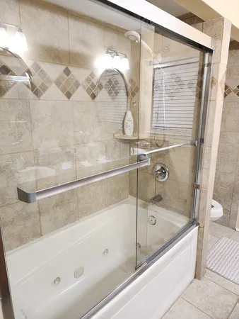 a bathroom with a bathtub and shower