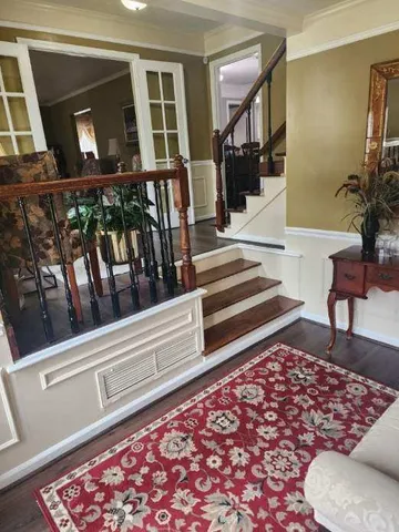 a view of staircase with a rug and a window