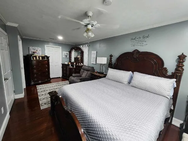 a large bedroom with bed and a chandelier