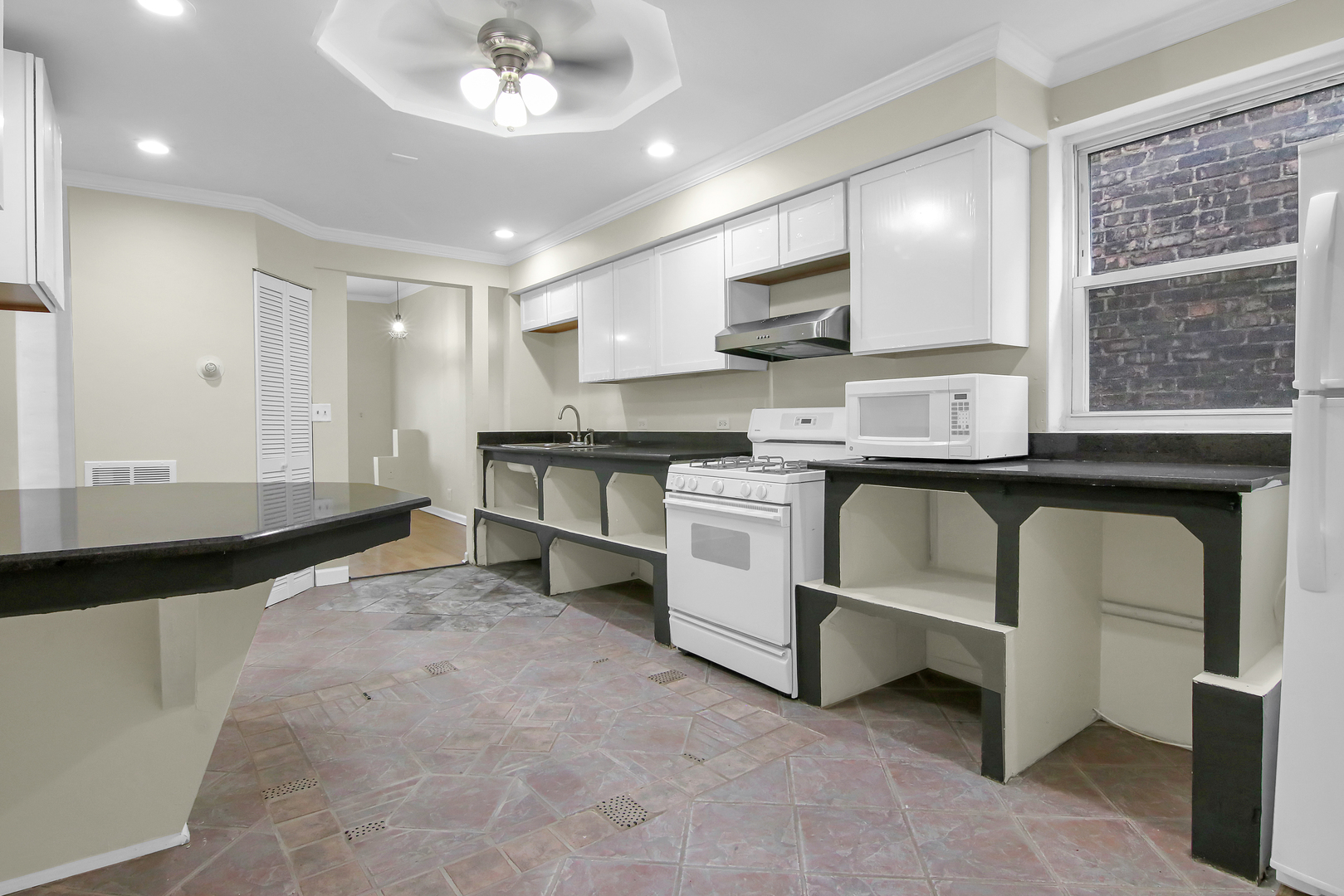2740 South Troy Street, Unit 1F Chicago, IL 60623 - Photo 12 of 13 a kitchen with stainless steel appliances granite countertop a stove a sink and a refrigerator