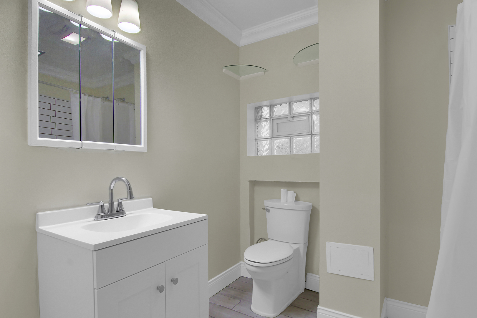 2740 South Troy Street, Unit 1F Chicago, IL 60623 - Photo 13 of 13 a bathroom with a toilet a sink a mirror and vanity