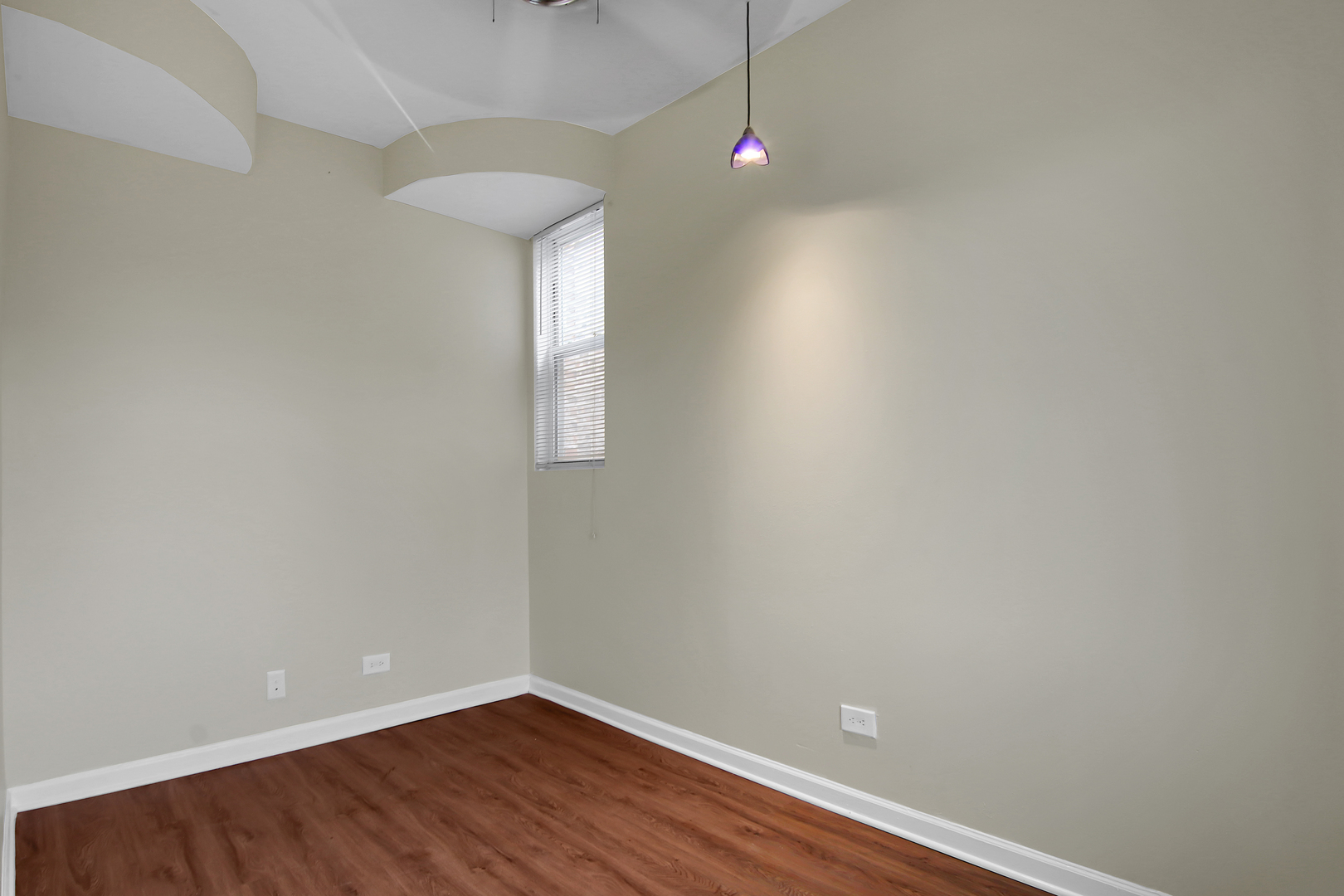 2740 South Troy Street, Unit 1F Chicago, IL 60623 - Photo 4 of 13 a view of a room with wooden floor and fan