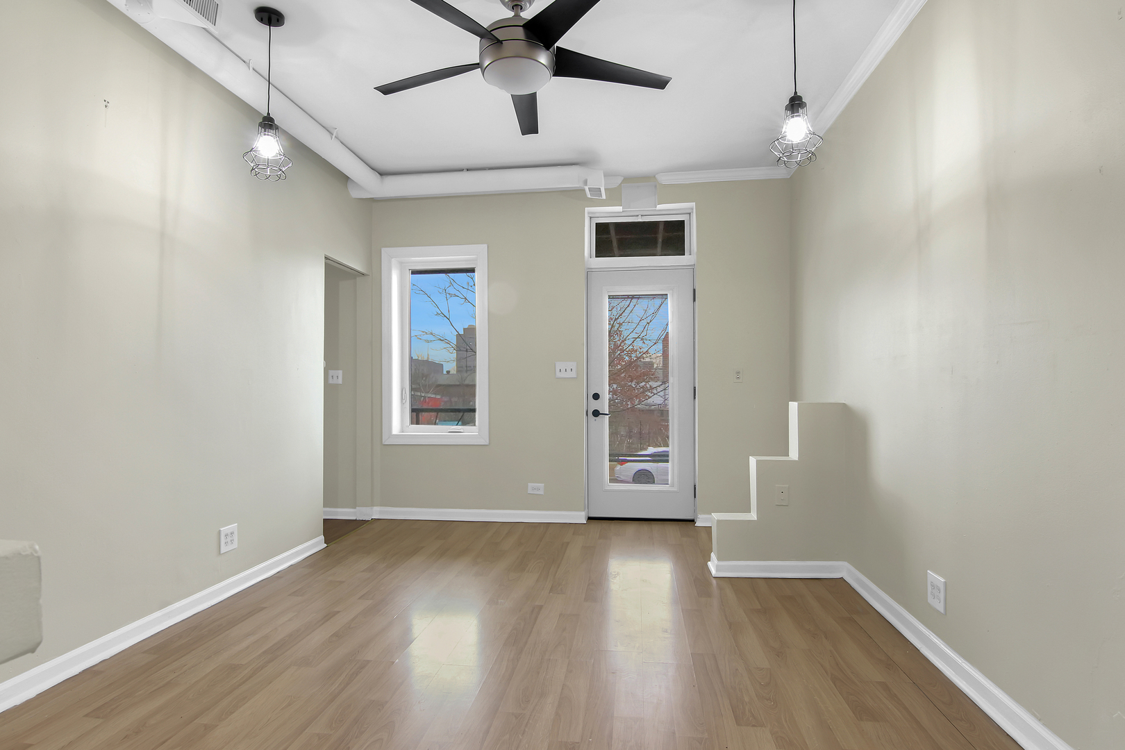 2740 South Troy Street, Unit 1F Chicago, IL 60623 - Photo 7 of 13 an empty room with wooden floor and windows