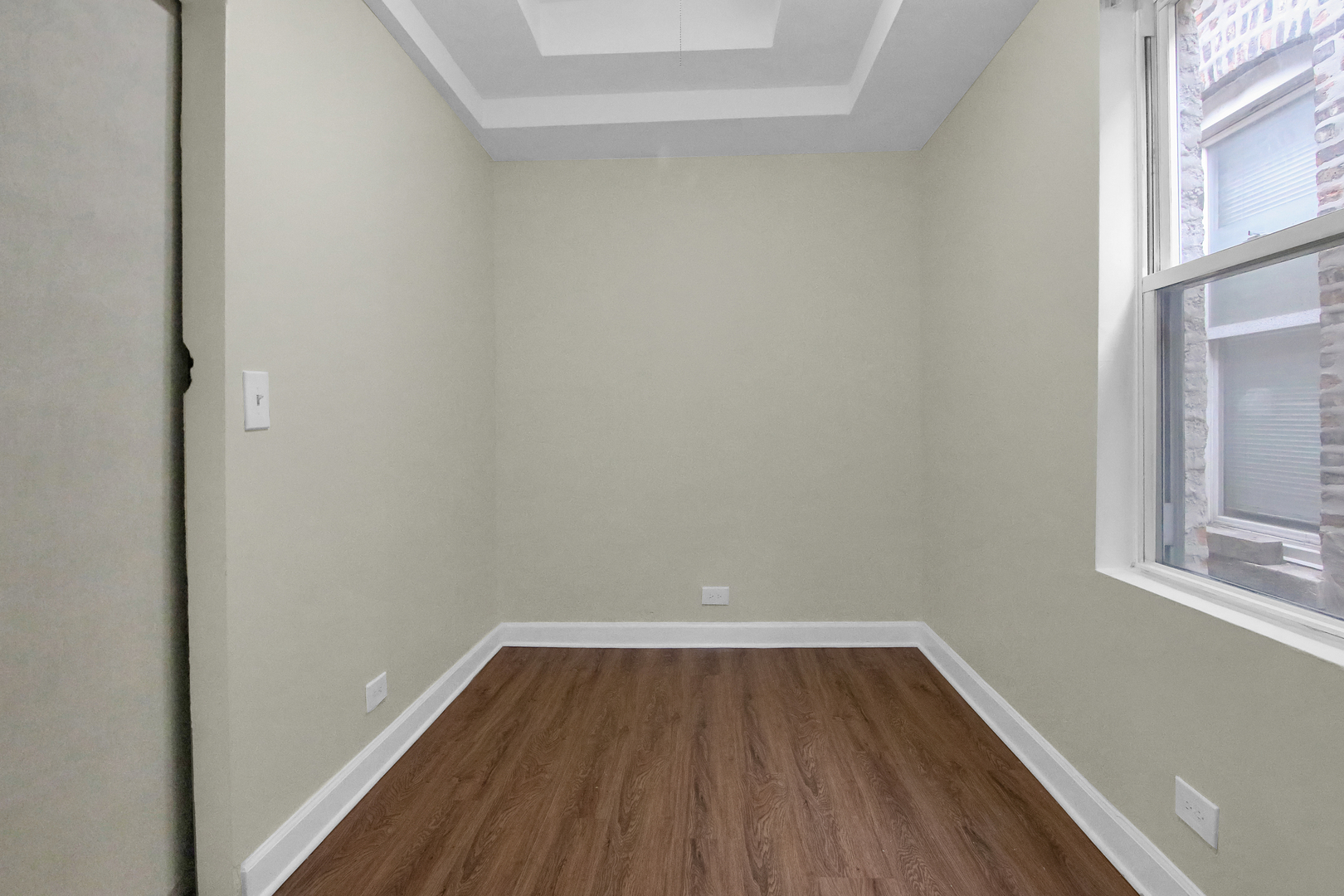 2740 South Troy Street, Unit 1F Chicago, IL 60623 - Photo 9 of 13 a view of a room with wooden floor and a window