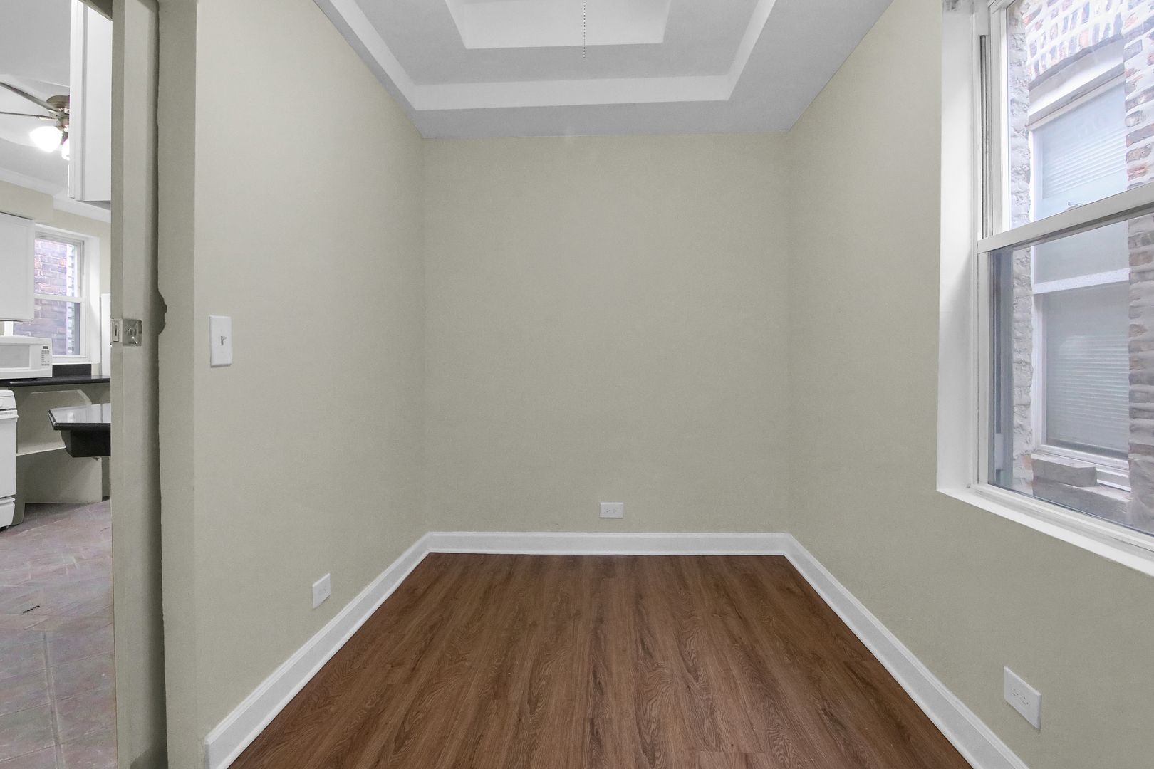 2740 South Troy Street, Unit 1F Chicago, IL 60623 - Photo 10 of 13 a view of a room with wooden floor and a window