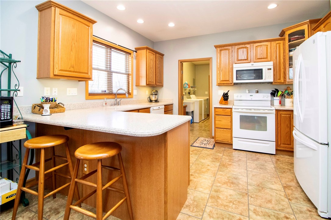 1000 Stone Road Xenia, OH 45385 - Photo 9 of 39 This spacious kitchen offers a functional layout with ample counter space and convenient laundry access.