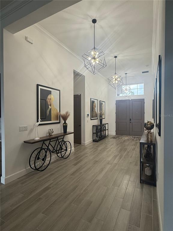 1088 Signet Drive Apollo Beach, FL 33572 - Photo 12 of 49 a view of a livingroom with furniture chandelier wooden floor and windows