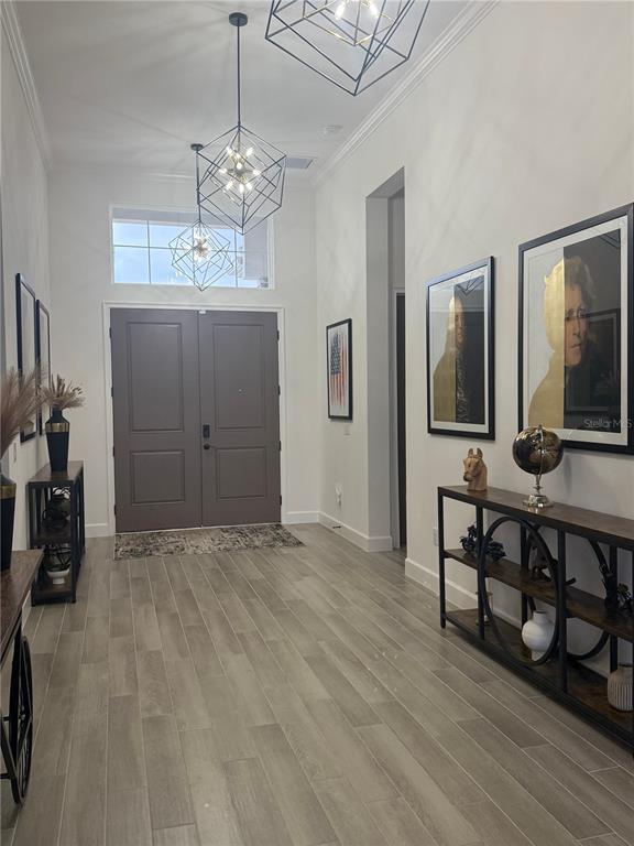 1088 Signet Drive Apollo Beach, FL 33572 - Photo 13 of 49 a view of a room with gym equipment and chandelier
