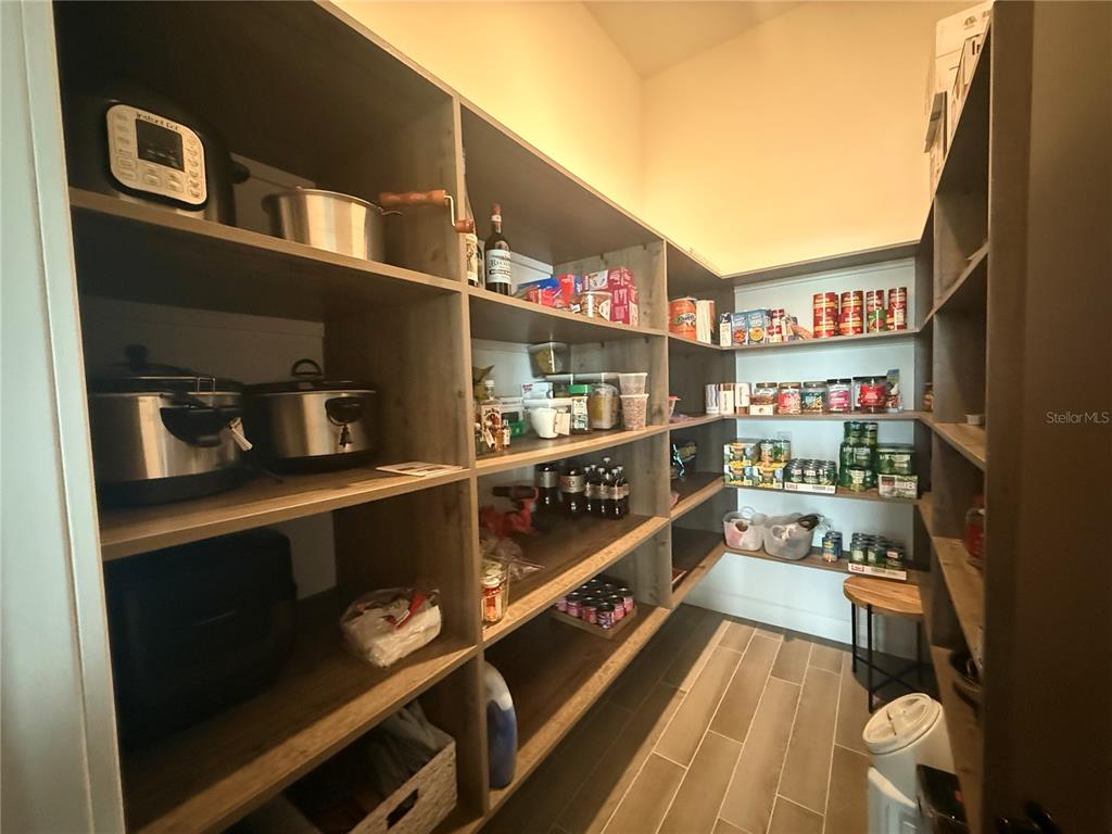 1088 Signet Drive Apollo Beach, FL 33572 - Photo 17 of 49 a kitchen with lots of clutter and cabinets