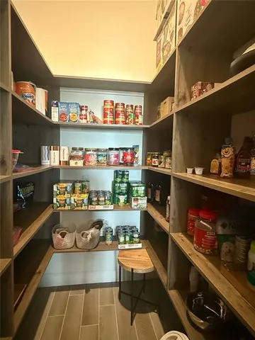 a bed room with a bed a television and a large window