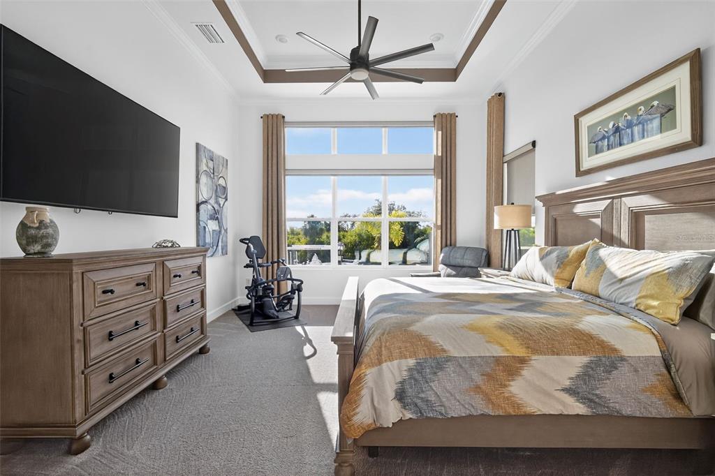 1088 Signet Drive Apollo Beach, FL 33572 - Photo 21 of 49 a bed room with a bed a television and a large window