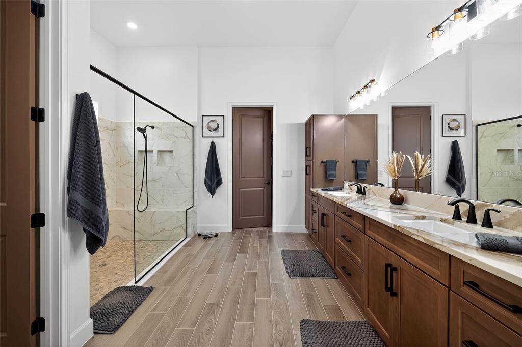 1088 Signet Drive Apollo Beach, FL 33572 - Photo 22 of 49 a spacious bathroom with a double vanity sink a large mirror a shower and a bathtub
