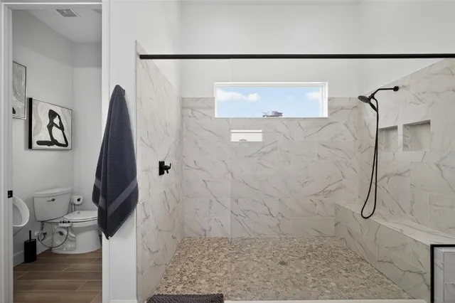 a bedroom with a bed next to a window