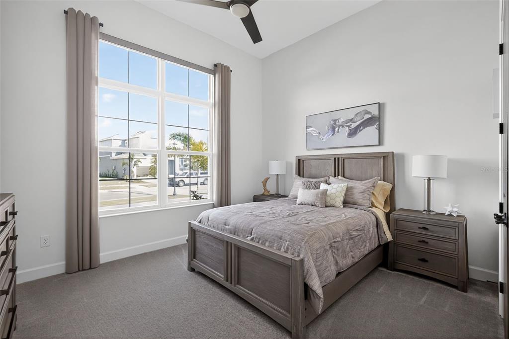 1088 Signet Drive Apollo Beach, FL 33572 - Photo 26 of 49 a bedroom with a bed next to a window